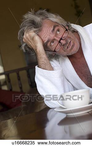 Stock Photography - Man in bathrobe drinking coffee. Fotosearch