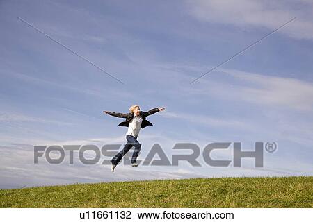 Man jumping on grass View Large Photo Image Stock Image - Man jumping on grass. Fotosearch