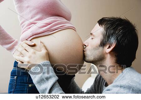 Man kissing woman's pregnant stomach View Large Photo Image Stock Image - Man kissing woman's pregnant stomach. Fotosearch