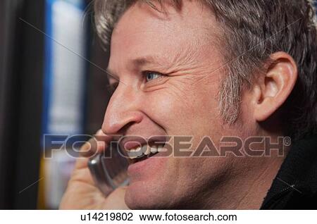 Stock Image - Man on cell phone. Fotosearch