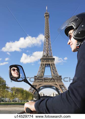 Picture - Man on moped in Paris. Fotosearch
