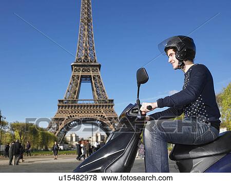 Stock Photo - Man on moped in Paris. Fotosearch