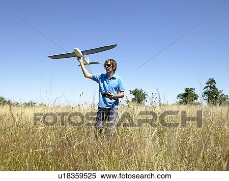 Man playing with remote-controlled plane View Large Photo Image Stock Photography - Man playing with remote-controlled plane. Fotosearch