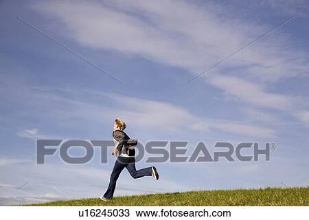 Man running on grass View Large Photo Image Stock Image - Man running on grass. Fotosearch