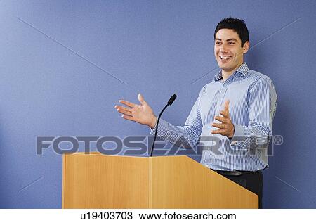 Man talking from lectern View Large Photo Image Stock Image - Man talking from lectern. Fotosearch