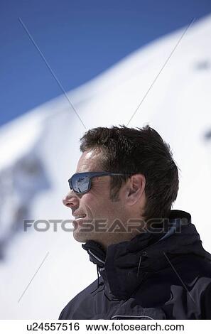 Man wearing sunglasses on mountain View Large Photo Image Stock Photograph - Man wearing sunglasses on mountain. Fotosearch