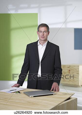 Manager standing in loft office View Large Photo Image Stock Image - Manager standing in loft office. Fotosearch