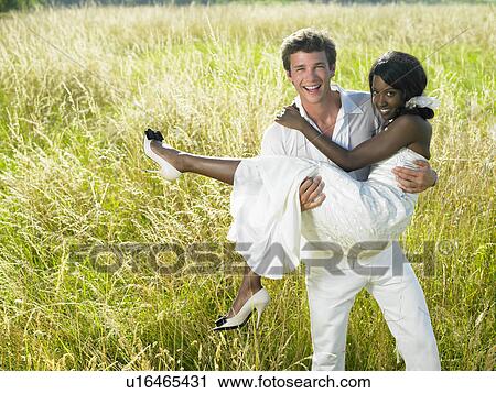 Stock Image - Married couple in a field. Fotosearch