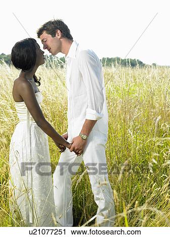 Stock Image - Married couple in a field. Fotosearch