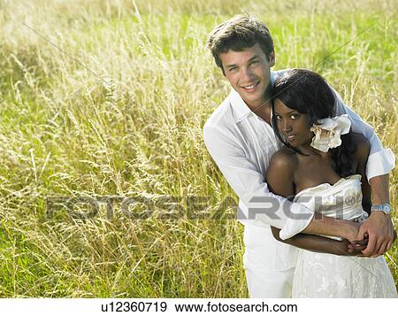 Married couple in a field View Large Photo Image Stock Photo - Married couple in a field. Fotosearch