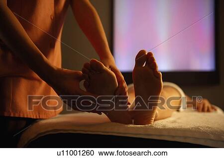 Masseuse massaging feet View Large Photo Image Stock Image - Masseuse massaging feet. Fotosearch