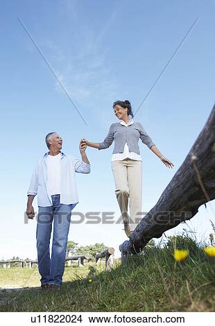 Mature couple holding hands View Large Photo Image Picture - Mature couple holding hands. Fotosearch