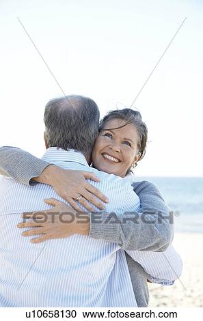 Mature couple hugging each other View Large Photo Image Stock Image - Mature couple hugging each other. Fotosearch