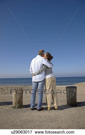 Stock Photo - Mature couple kissing in front of view. Fotosearch