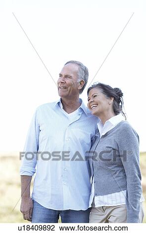 Stock Image - Mature couple laughing together. Fotosearch