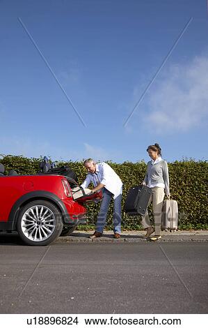 Mature couple putting bags into car View Large Photo Image Picture - Mature couple putting bags into car. Fotosearch