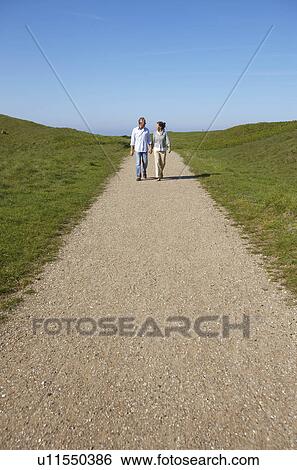 Stock Photograph - Mature couple walking together. Fotosearch