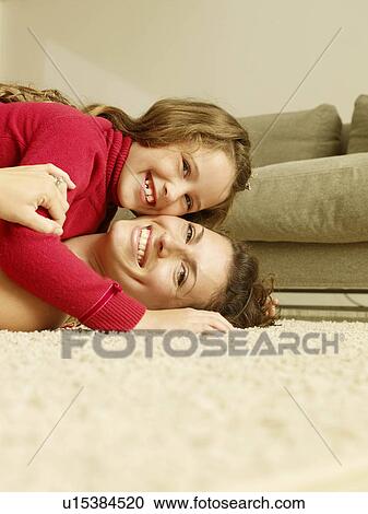 "Mom and girl on floor, looking at camera" View Large Photo Image Stock Image - "Mom and girl on floor, looking at camera". Fotosearch