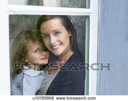 Mother and daughter behind window View Large Photo Image Stock Photo - Mother and daughter behind window. Fotosearch