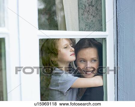 Stock Photo - Mother and daughter behind window. Fotosearch