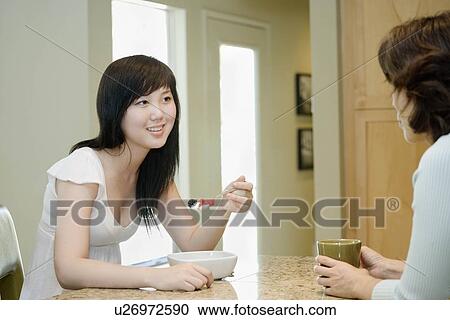 Mother and daughter eating breakfast View Large Photo Image Stock Image - Mother and daughter eating breakfast. Fotosearch