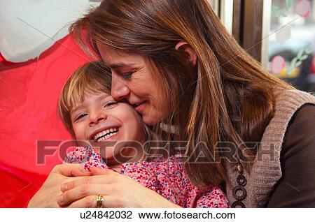 Stock Image - Mother and daughter hugging. Fotosearch