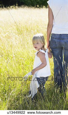 Stock Image - Mother and daughter in a field. Fotosearch