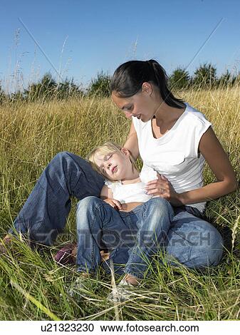 Stock Image - Mother and daughter in a field. Fotosearch