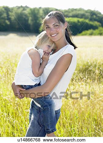 Mother and daughter in a field View Large Photo Image Stock Photo - Mother and daughter in a field. Fotosearch