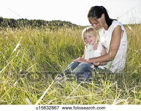 Stock Photo - Mother and daughter in a field. Fotosearch