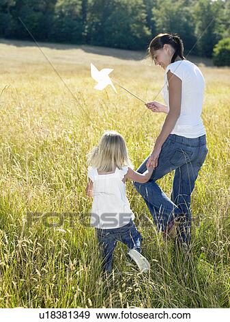 Mother and daughter in a field View Large Photo Image Stock Photo - Mother and daughter in a field. Fotosearch