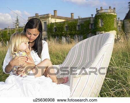 Mother and daughter on sofa in a field View Large Photo Image Stock Photo - Mother and daughter on sofa in a field. Fotosearch