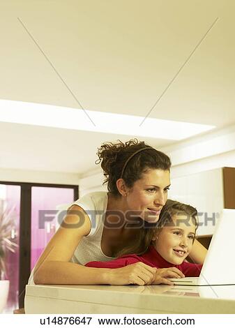 Stock Photo - Mother and daughter using laptop. Fotosearch