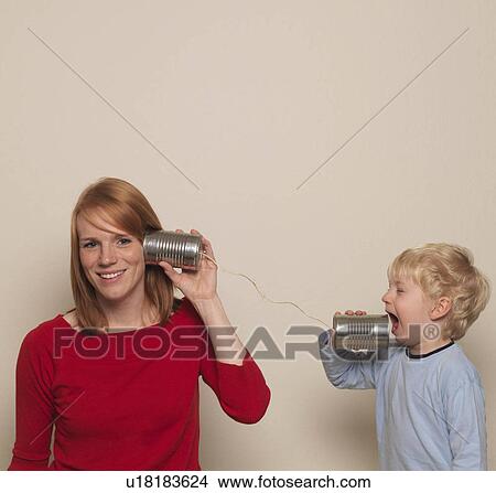 Mother and son playing with can phone View Large Photo Image Picture - Mother and son playing with can phone. Fotosearch