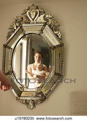 "Mother holding baby, looking in mirror" View Large Photo Image Stock Photography - "Mother holding baby, looking in mirror". Fotosearch