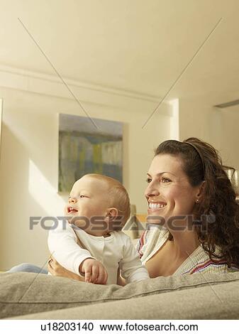 "Mother holding baby, side view" View Large Photo Image Stock Image - "Mother holding baby, side view". Fotosearch