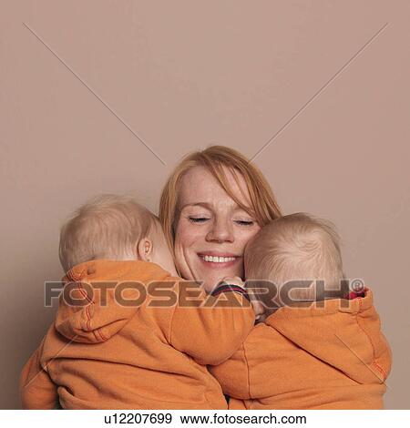 Mother holding twin sons View Large Photo Image Stock Photo - Mother holding twin sons. Fotosearch