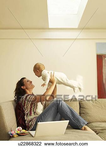 Mother holding up baby View Large Photo Image Stock Image - Mother holding up baby. Fotosearch