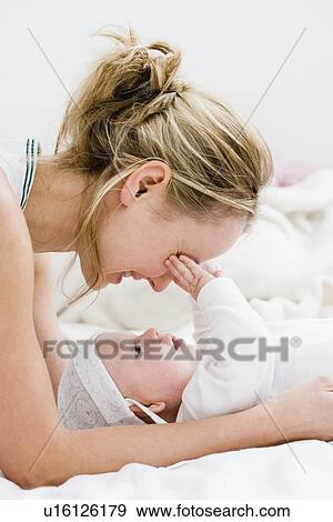 Stock Photo - Mother hugging her baby. Fotosearch