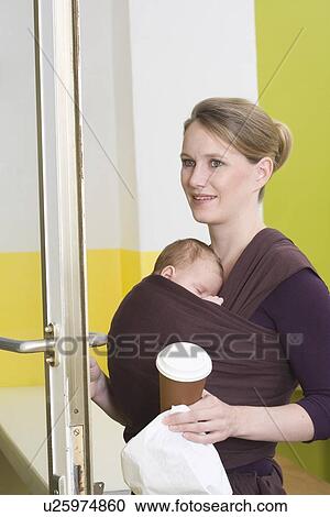 Mother in shop with baby in baby sling View Large Photo Image Stock Image - Mother in shop with baby in baby sling. Fotosearch