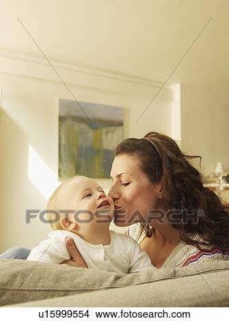 Picture - Mother kissing baby. Fotosearch