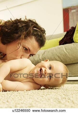 Stock Image - Mother kissing baby. Fotosearch