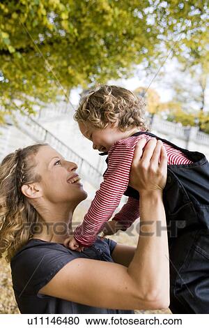 Stock Image - Mother playing with child. Fotosearch