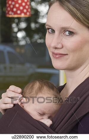 Mother with baby in baby sling View Large Photo Image Stock Image - Mother with baby in baby sling. Fotosearch