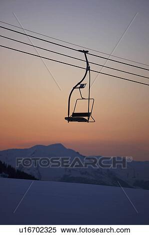 Stock Photography - Mountain view at dusk with chair lift. Fotosearch