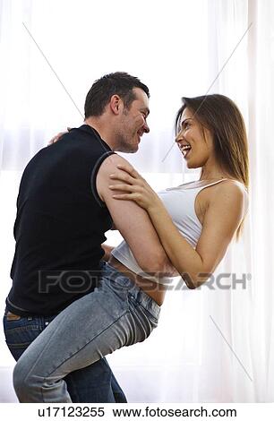 Natural image of young couple at home View Large Photo Image Stock Photography - Natural image of young couple at home. Fotosearch