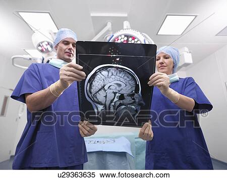 Stock Photography - Nurses looking at x-ray. Fotosearch