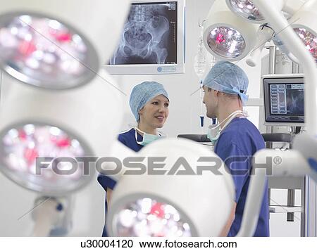 Nurses talking in operating theatre View Large Photo Image Stock Image - Nurses talking in operating theatre. Fotosearch