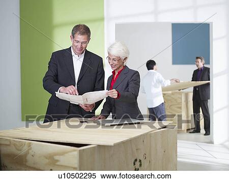 Stock Photography - Office team moving into loft. Fotosearch