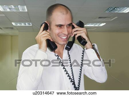 Office worker holding three phones View Large Photo Image Stock Photo - Office worker holding three phones. Fotosearch
